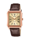 A Casio rectangular analog watch with a rose gold-tone case, cream-colored dial with black Roman numerals, and a dark brown textured leather strap, shown against a plain white background.